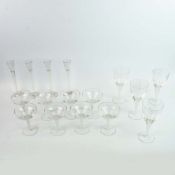 SET OF SIXTEEN SWIRL GLASS DRINKING GLASSES OF VARIOUS TYPES.