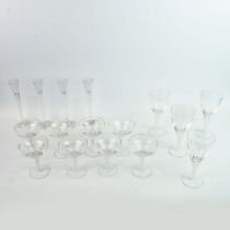 SET OF SIXTEEN SWIRL GLASS DRINKING GLASSES OF VARIOUS TYPES.