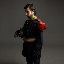 A COLLECTION OF MILITARY UNIFORMS.