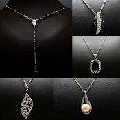 A COLLECTION OF FIVE SILVER PENDANT NECKLACES.