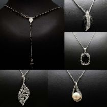 A COLLECTION OF FIVE SILVER PENDANT NECKLACES.