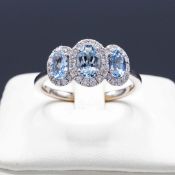 A PLATINUM AQUAMARINE AND DIAMOND TRILOGY RING.