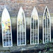 A SET OF FOUR ARCHITECTURAL GARDEN MIRRORS.