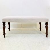 FOOTSOOL WITH NEUTRAL LINEN UPHOLSTERY.