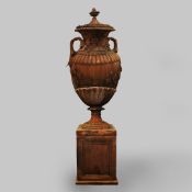 LARGE TERRACOTTA URN ON PLINTH.