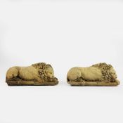 SCULPTURAL RECUMBENT LIONS, A PAIR.