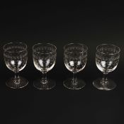 A SET OF FOUR ETCHED WINE GLASSES (4).