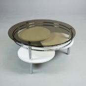 1970s SPACE AGE COFFEE TABLE IN CHROME AND GLASS WITH THREE TIERED REVOLVING SHELVES.