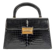 A Fernande DesGranges, 1950’s, patent black crocodile bag with gold metal features and three