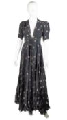 An OSSIE CLARK, 1970s long dress with pleated skirt, in a black and floral print by Celia