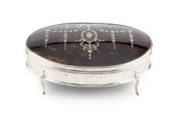 A George V silver and tortoiseshell large jewellery box, of oval form, the hinged cover piqué
