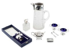 A pair of Edwardian silver twin handled salts of Art Nouveau design, with blue glass liners, by
