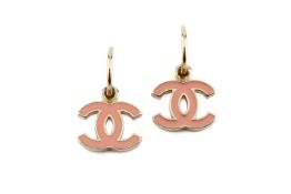 A pair of earrings by Chanel, each suspending a logo drop heightened with pale pink enamel, on