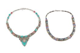 A Tibetan white metal and enamel necklace, with ropetwist applied decoration and inset with blue,