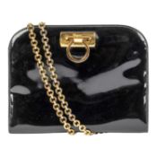 A SALVATORE FERRAGAMO patent black bag with gold metal shoulder strap, Made Italy. A very good