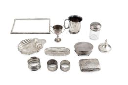 A small collection of assorted silver, to include a christening mug, a butter shell, an oval trinket