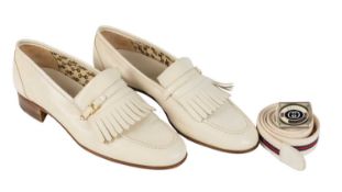 A GUCCI pair of men’s loafers in white with fringed tops, size 42 ½; Together with a belt