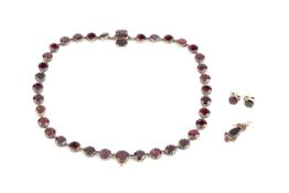 A 19th century garnet collar necklace, the slightly graduated circular-cut garnets in foiled
