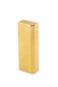 A gold plated lighter by Cartier, of reeded and chamfered rectangular design, stamped 'Cartier Paris