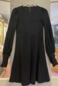 A BIBA little black dress with a round neck, long balloon sleeves and button cuffs, in a soft fine