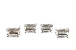 A set of four Edwardian silver salts, of rounded rectangular form with gadrooned borders and paw