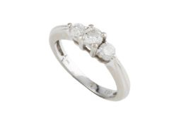A diamond three stone ring, the graduated round brilliant-cut diamonds in claw setting, white