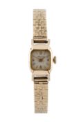 A 9ct gold bracelet watch, the cushion-shaped dial with Arabic numerals and baton markers, to a