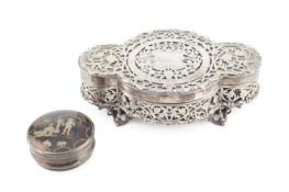 A George V silver trinket box, of quatrefoil outline, pierce-decorated with flowering foliage within