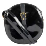 A black patent leather, cross body, oval Etienne Aigner ladies’ bag Zip closure, adjustable strap.