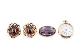 A pair of garnet ear clips, each oval cabochon garnet collet set within an openwork flower-shaped