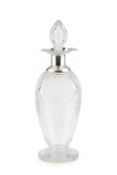 A George V silver mounted cut glass decanter and stopper, the silver mount of shaped quatreform