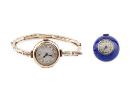 A bracelet watch, the circular silvered dial with Arabic numerals, on an expanding baton-link