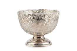 An Edwardian silver rose bowl, pierce-decorated with scrolling foliage and reserving two vacant