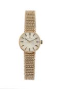 A lady's 9ct gold bracelet watch by Omega, the circular silvered dial with black insert baton