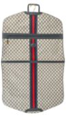 A GUCCI 1980's garment bag in GG monogram canvas, featuring a navy and red central strip, with