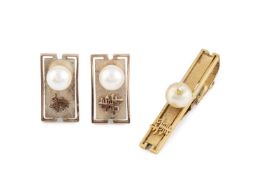 A pair of cultured pearl set cufflinks, with textured decoration and Eastern character marks, on