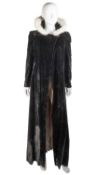 A long-sleeved cape in black velvet with pale pink lining and six silver buttons The Edwardian