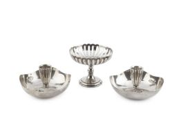 A pair of silver dished candle holders, of shaped circular form with lobed nozzles, by Albert Edward