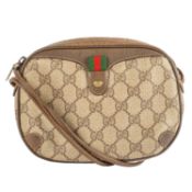 A Gucci cross body bag in GG Monogram coated fabric Beige and brown, zip closure, L. 20cm, H. 15cm