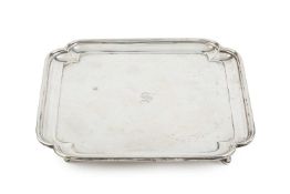 A George V silver salver, of square form with re-entrant corners, on pad feet, by Thomas