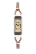 A lady's wristwatch, the rectangular cream dial with Roman numerals and blued steel hands, signed
