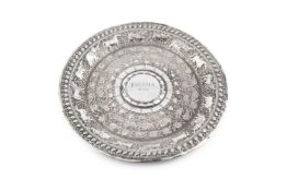 An Indian silver circular plate, embossed and engraved with friezes of wild animals, birds and