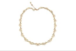 A fancy-link necklace, designed as a series of textured openwork panels, with extension chain