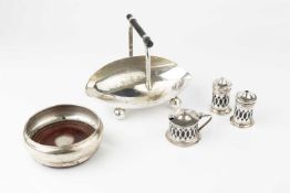 A silver plated sugar basket in the manner of Christopher Dresser, with fixed ebonised bar handle,