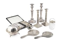 Two silver backed hand mirrors, a pair of silver plated candlesticks of reeded column form,