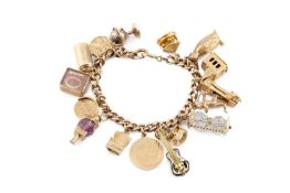 A charm bracelet, the curb-link bracelet stamped '9 .375', suspending assorted charms, to include