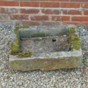 A carved limestone trough