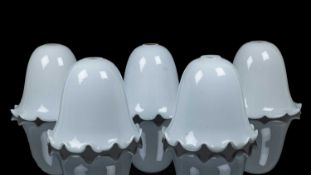 A group of four similar white-glass shades