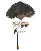 A collection of spectacles and a feathered fan