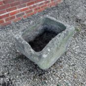 A rustic carved stone trough